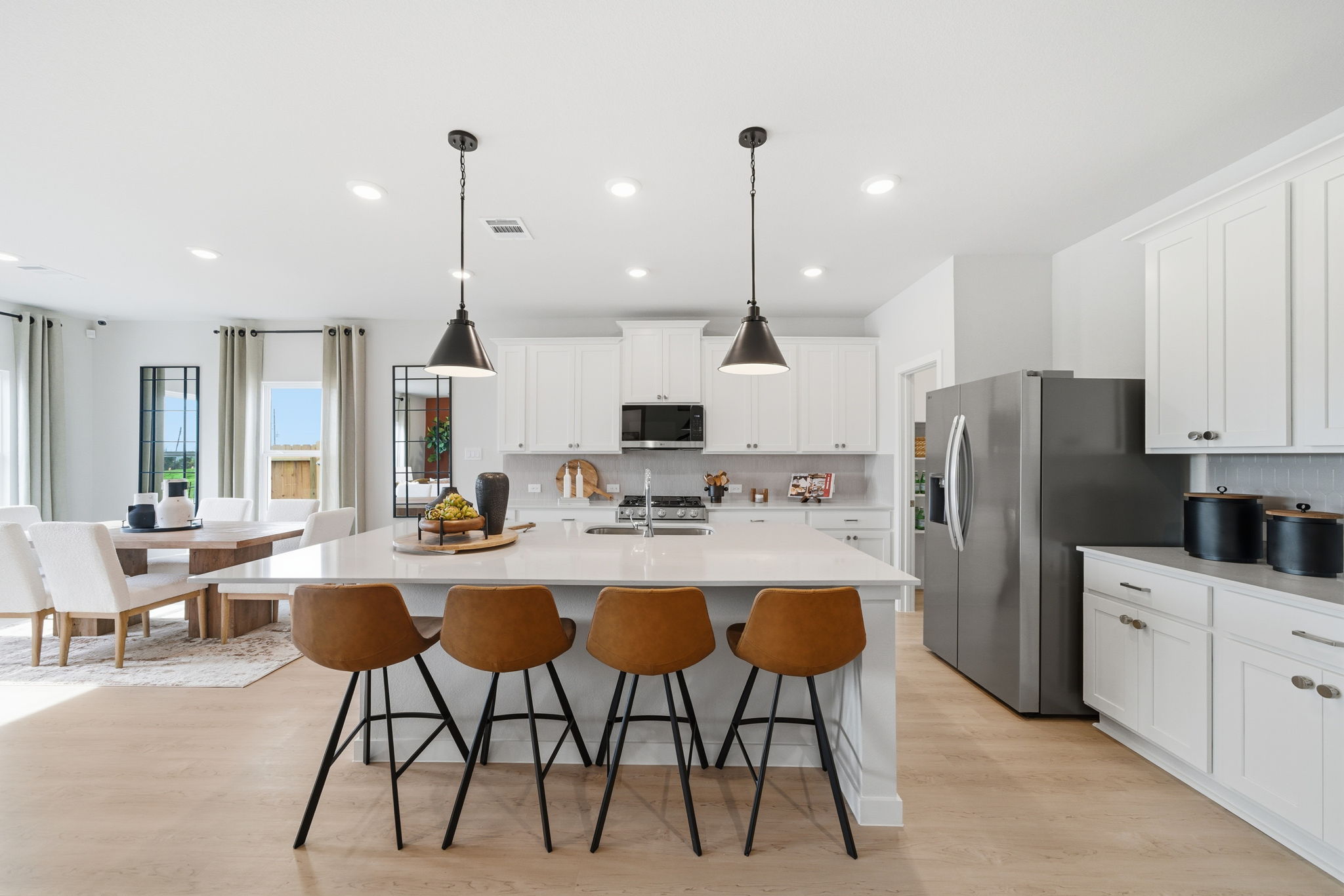 A kitchen with a table and chairs.