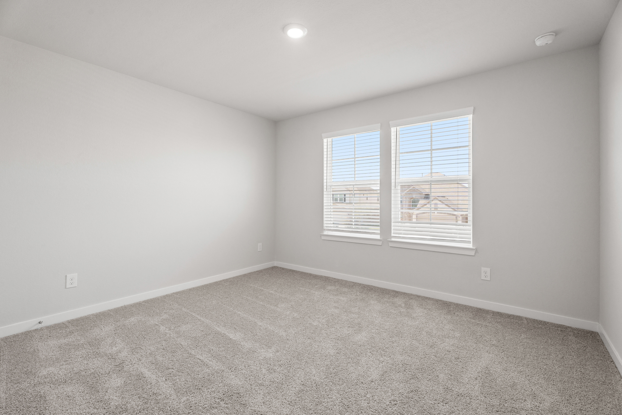 A room with a window and a carpet.