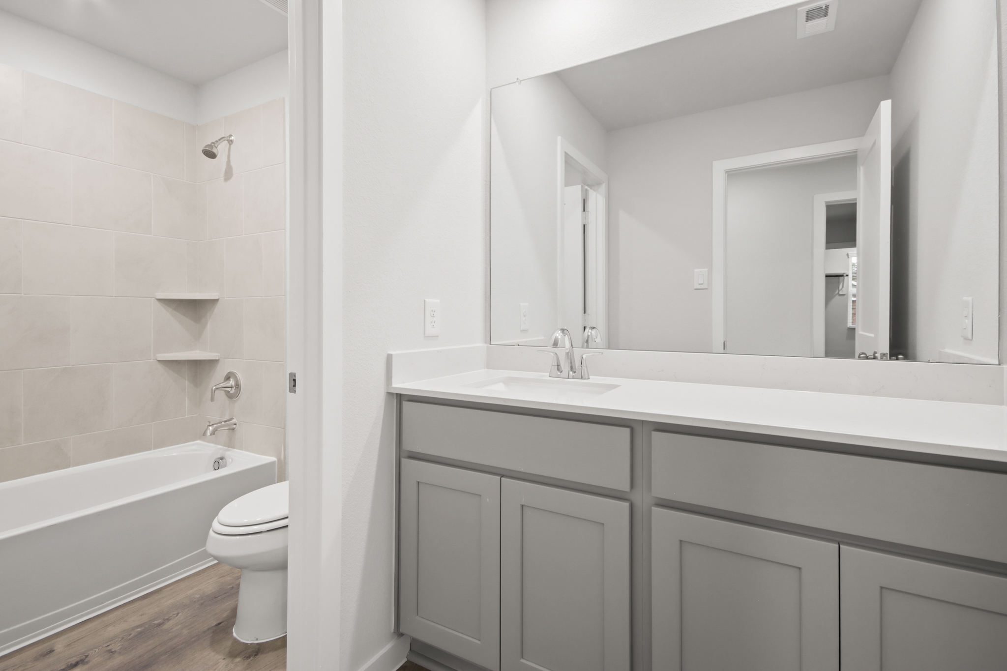 A bathroom with a tub sink and toilet.
