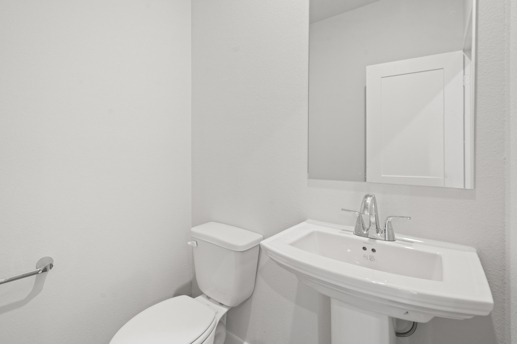 A bathroom with a toilet and sink.