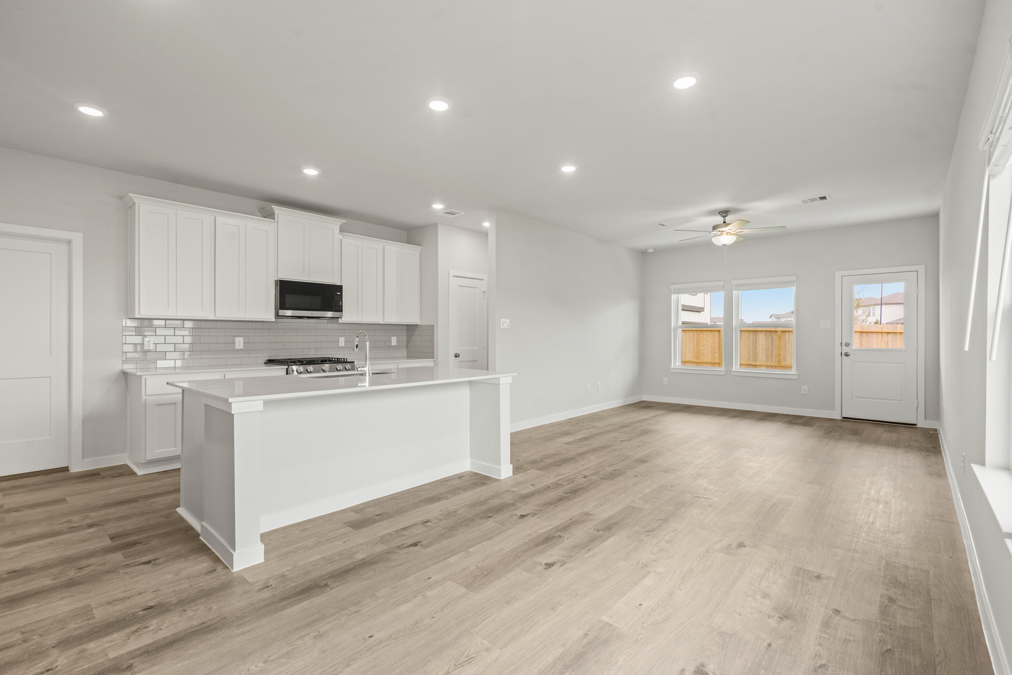 A kitchen with white cabinets.