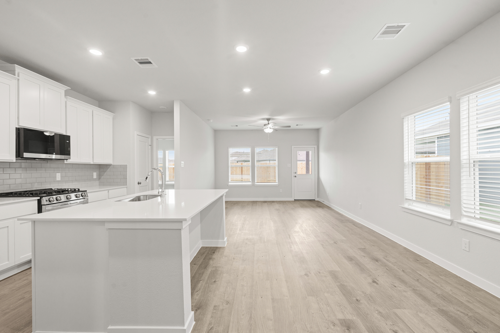 A kitchen with white cabinets.