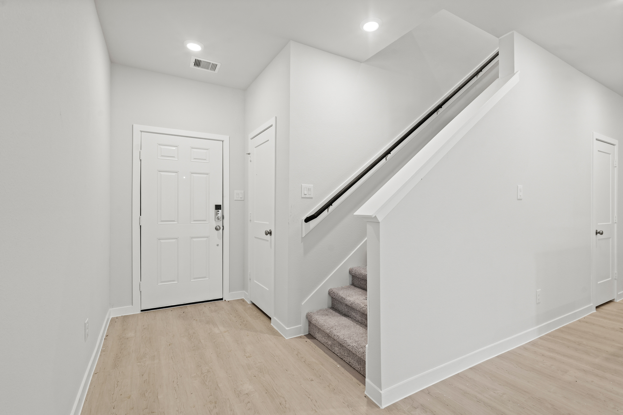 A white staircase in a room.