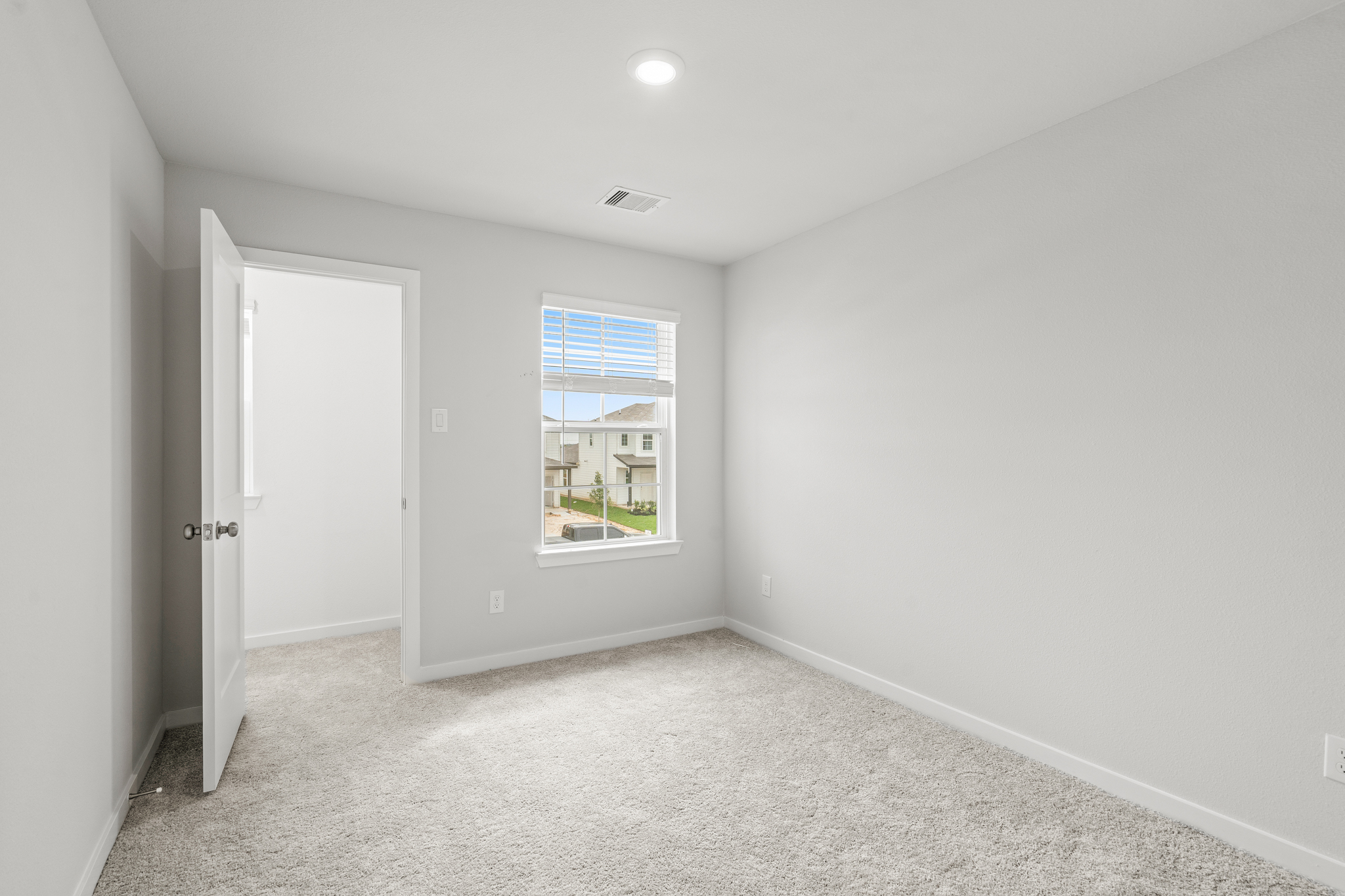 A room with a window and a door.