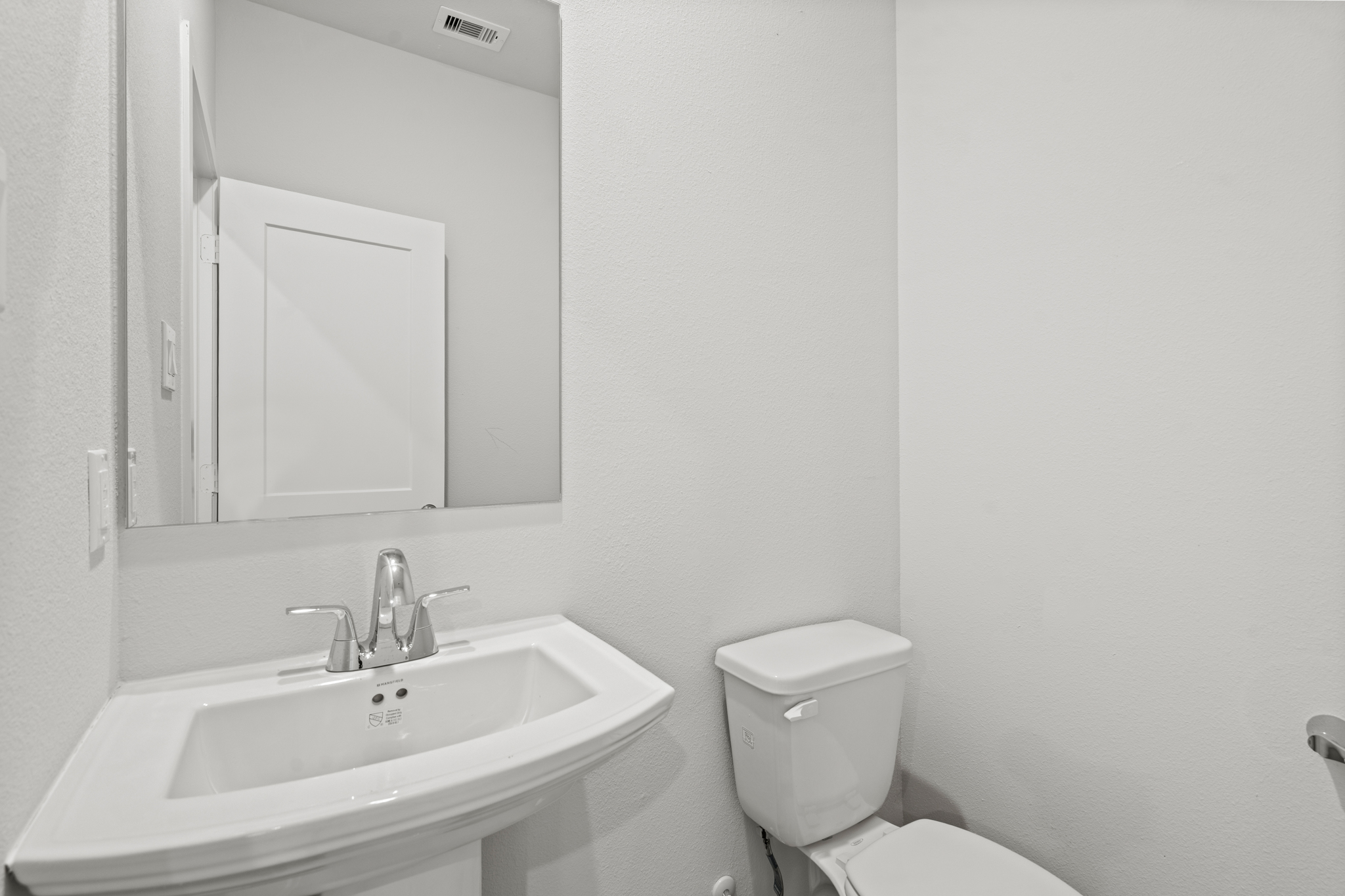 A bathroom with a sink and toilet.