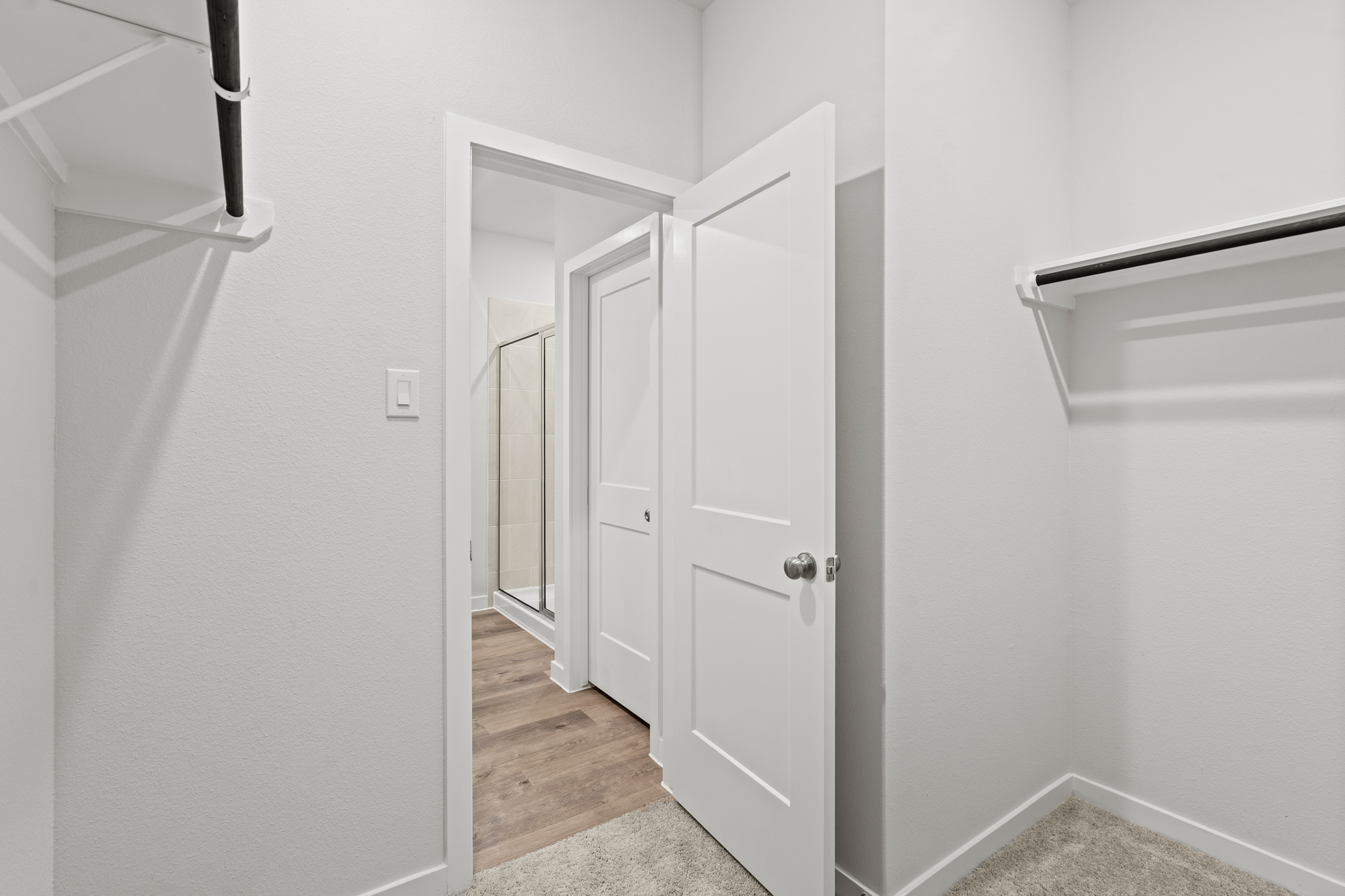 A hallway with white doors.