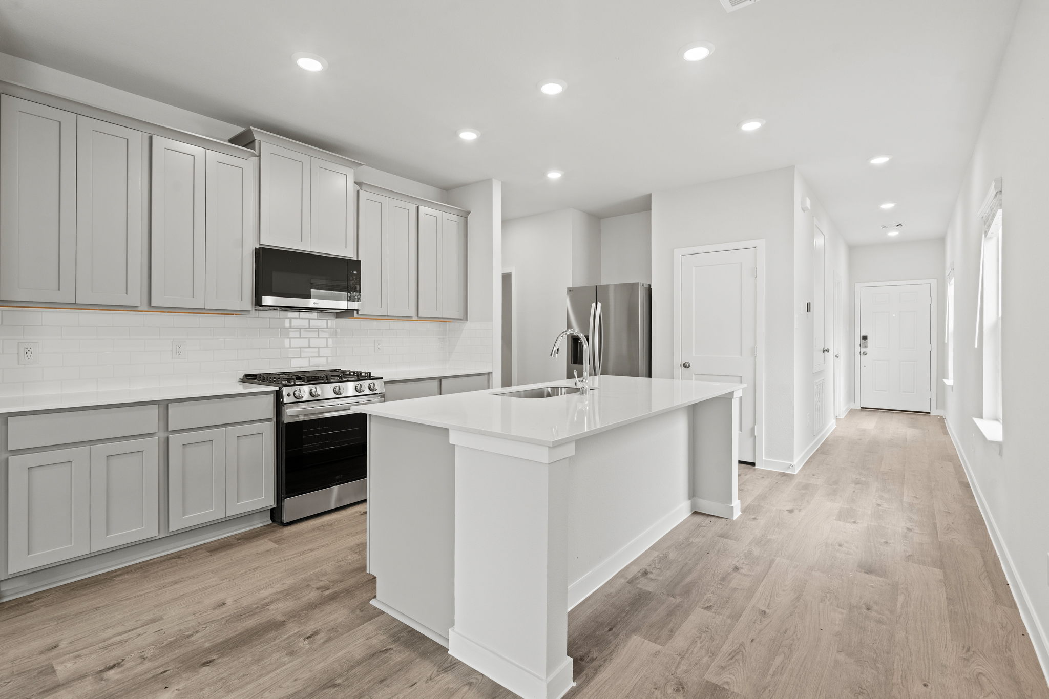 A kitchen with white cabinets.