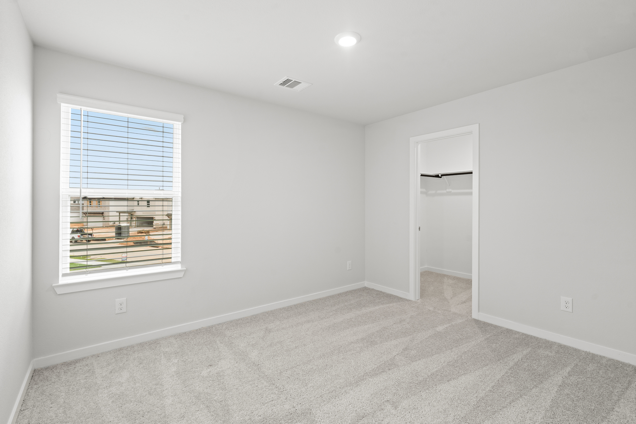 A room with a window and a door.