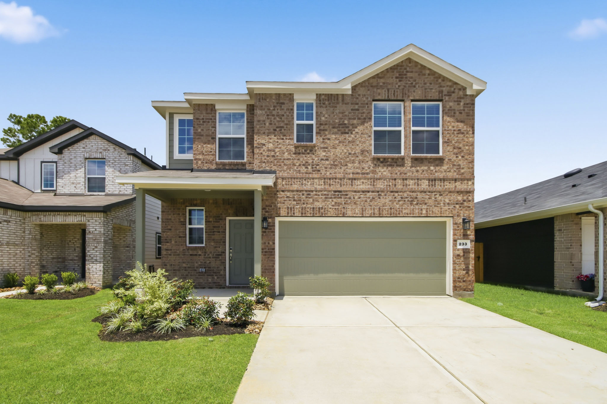 A brick house with a garage.