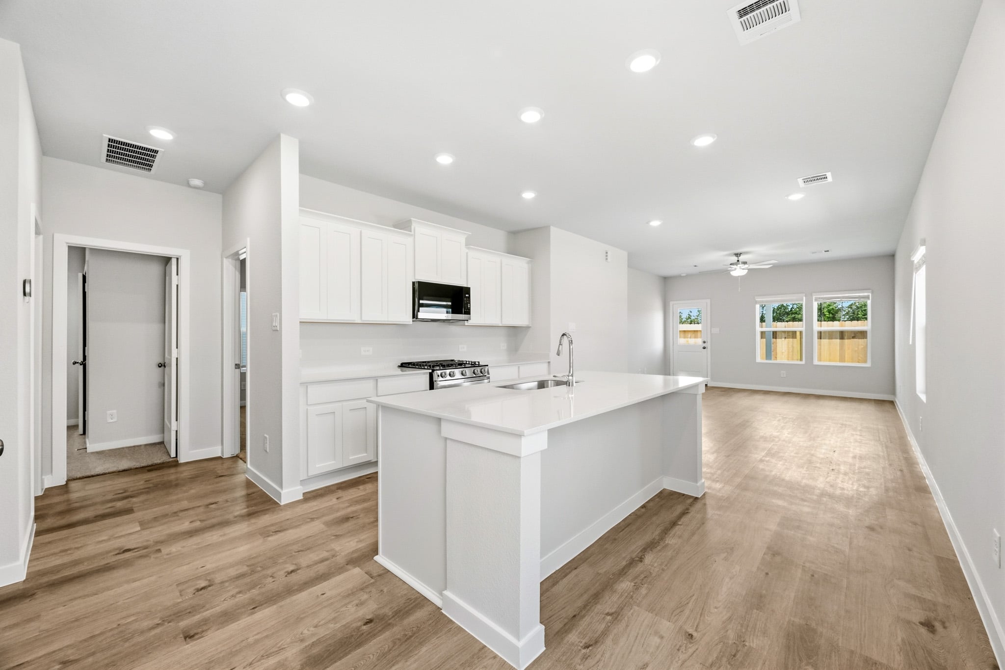 A kitchen with white cabinets.