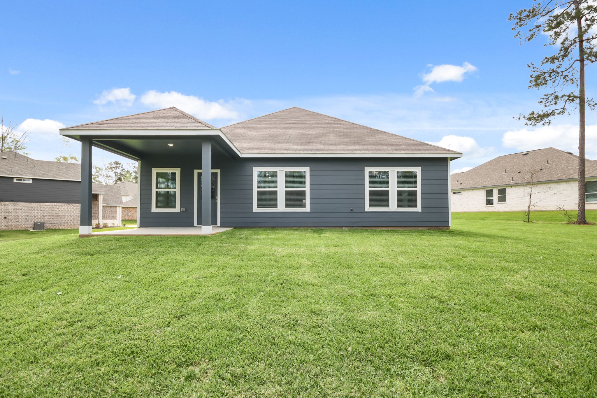 A house with a lawn in front of it.