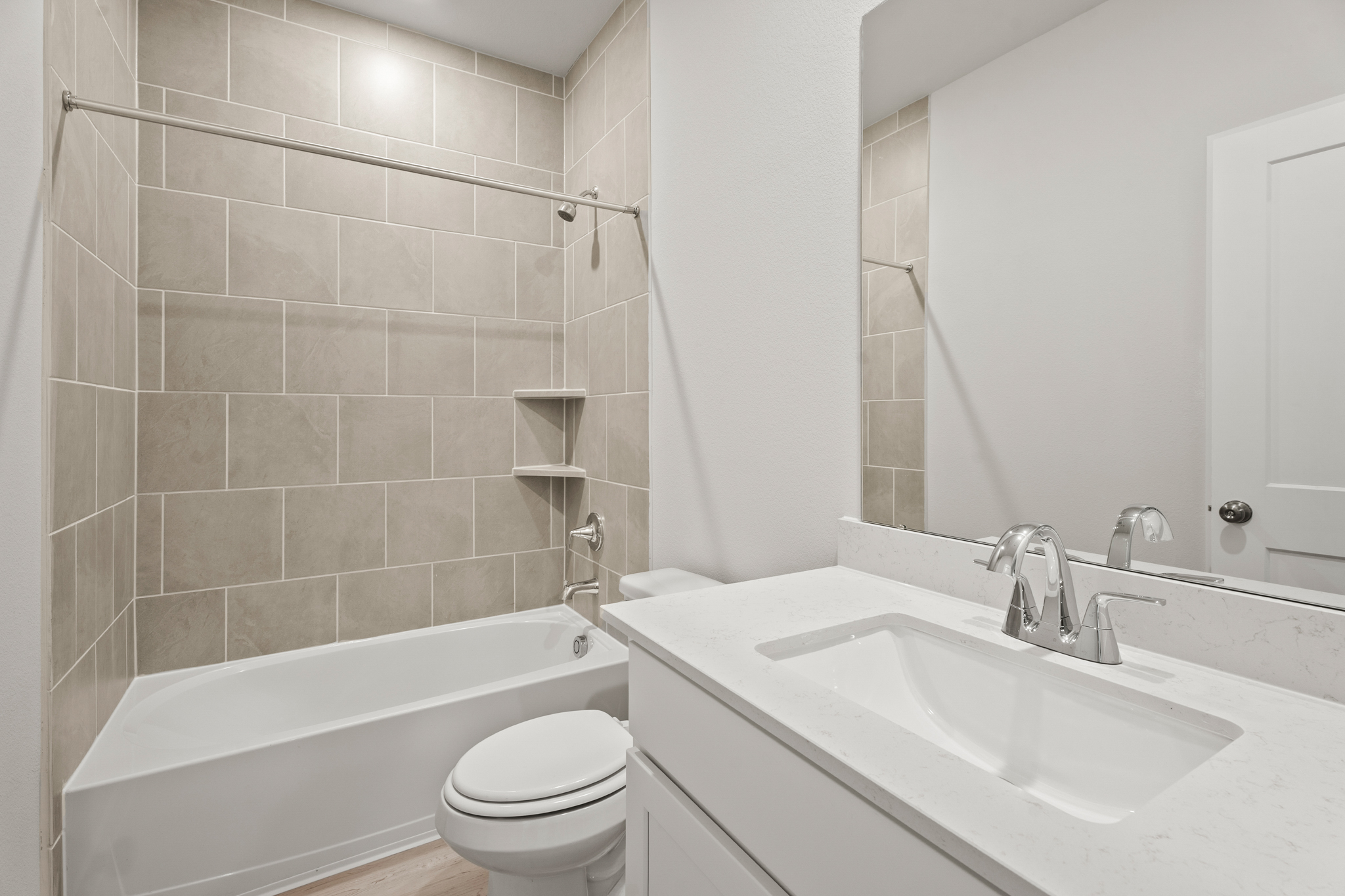 A bathroom with a tub sink and toilet.