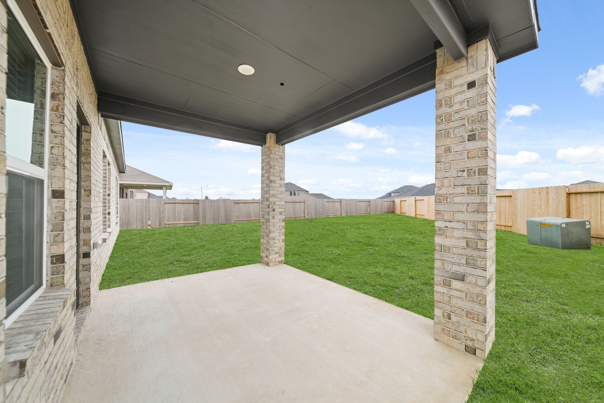 A walkway with a fence and grass.