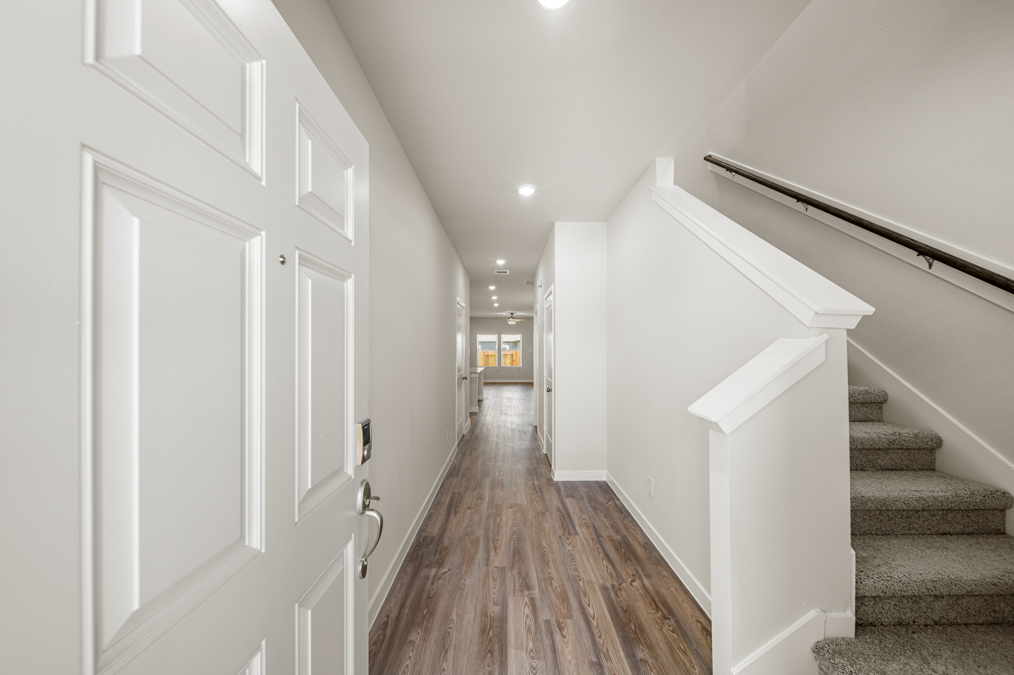 A hallway with white doors.