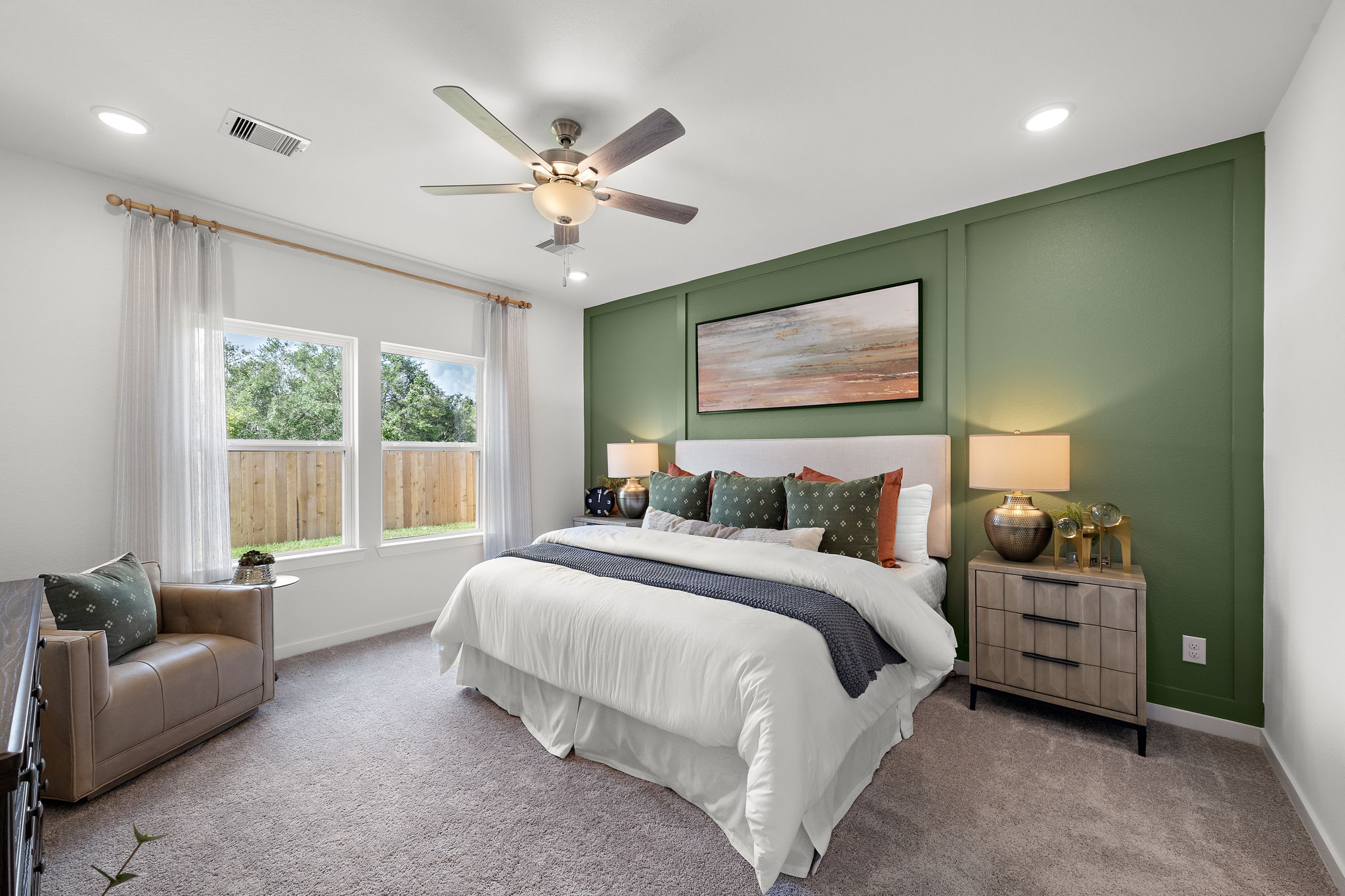A bedroom with a bed and a fan.