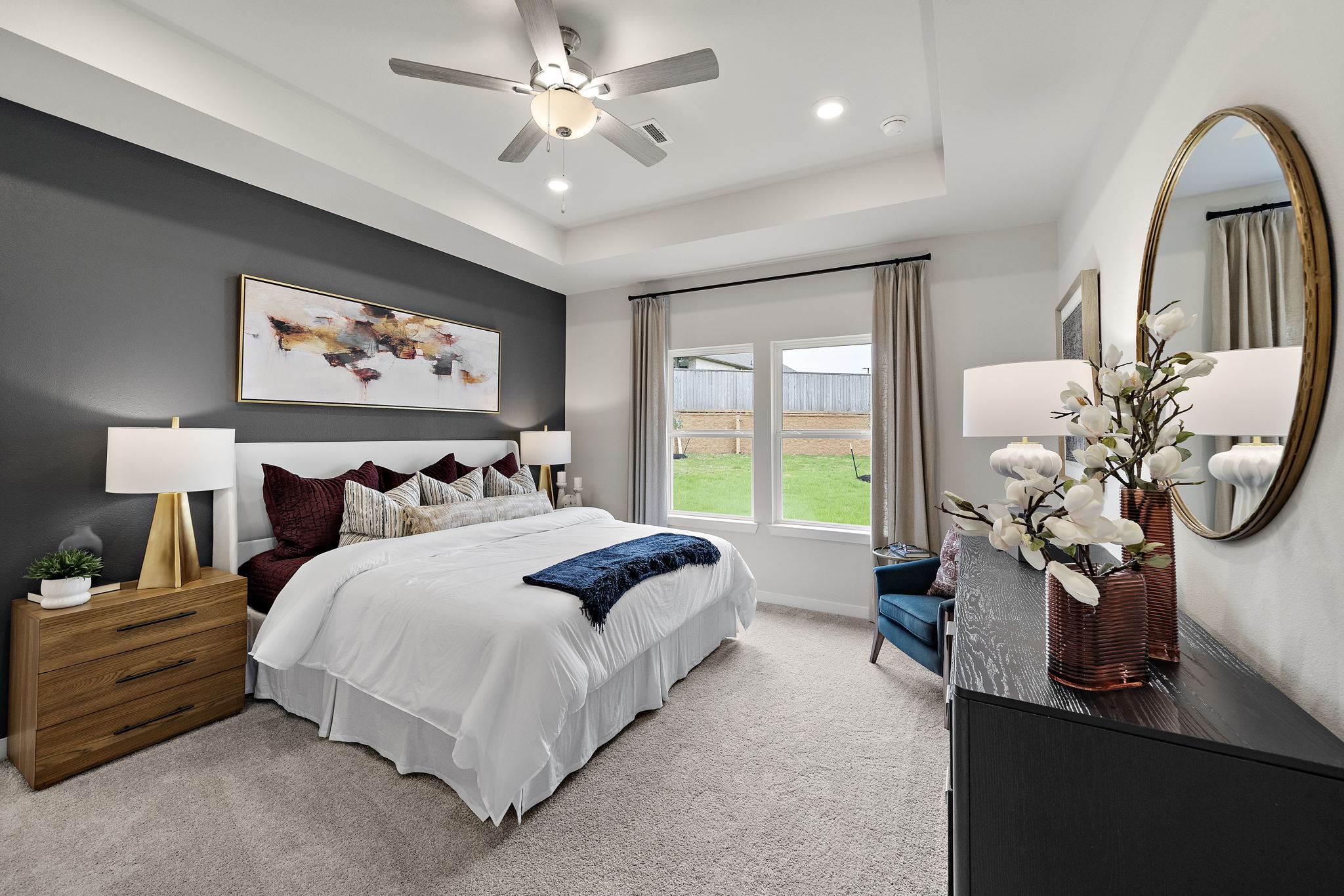 A bedroom with a large mirror.