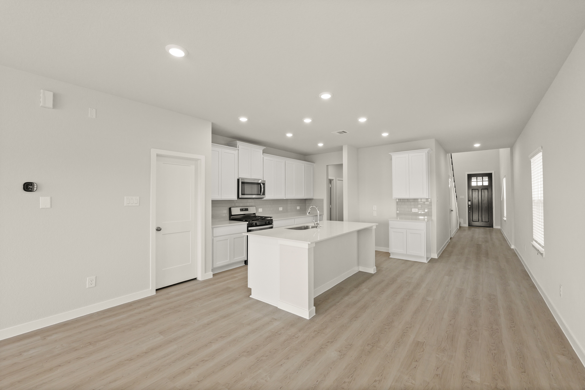 A large kitchen with white cabinets.