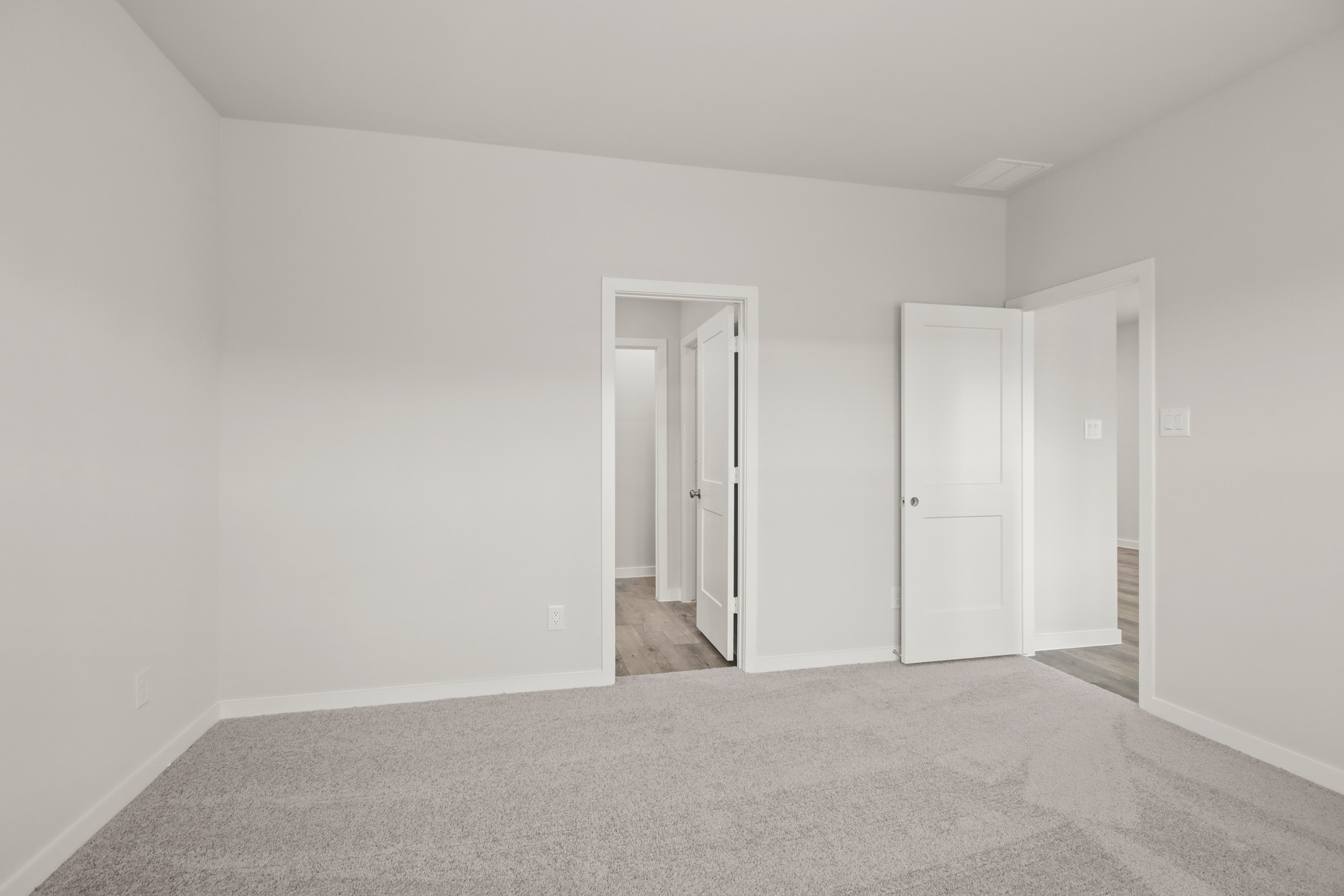 A hallway with white doors.
