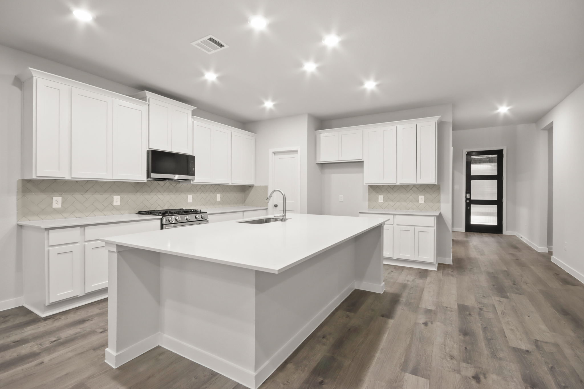 A kitchen with white cabinets.
