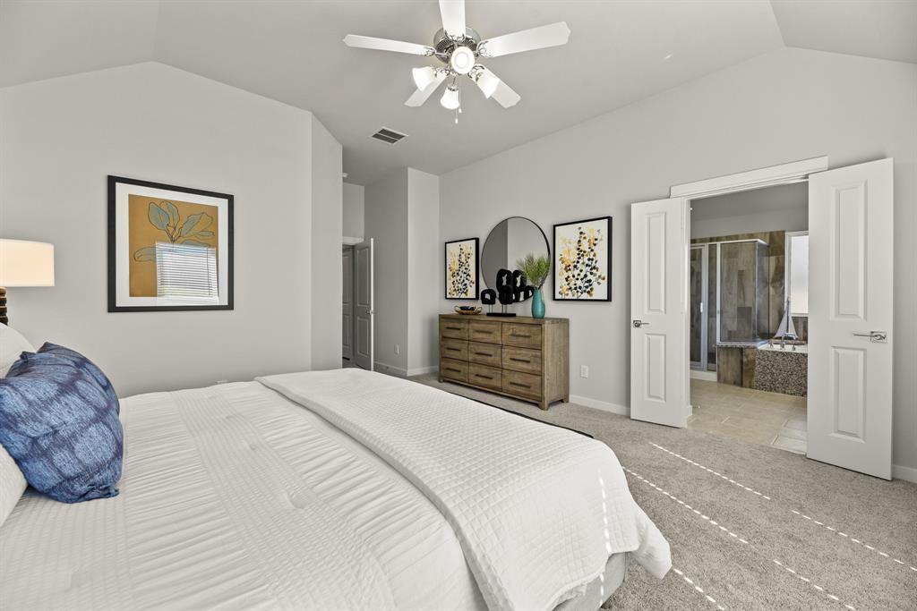 A bedroom with a bed and a fan.