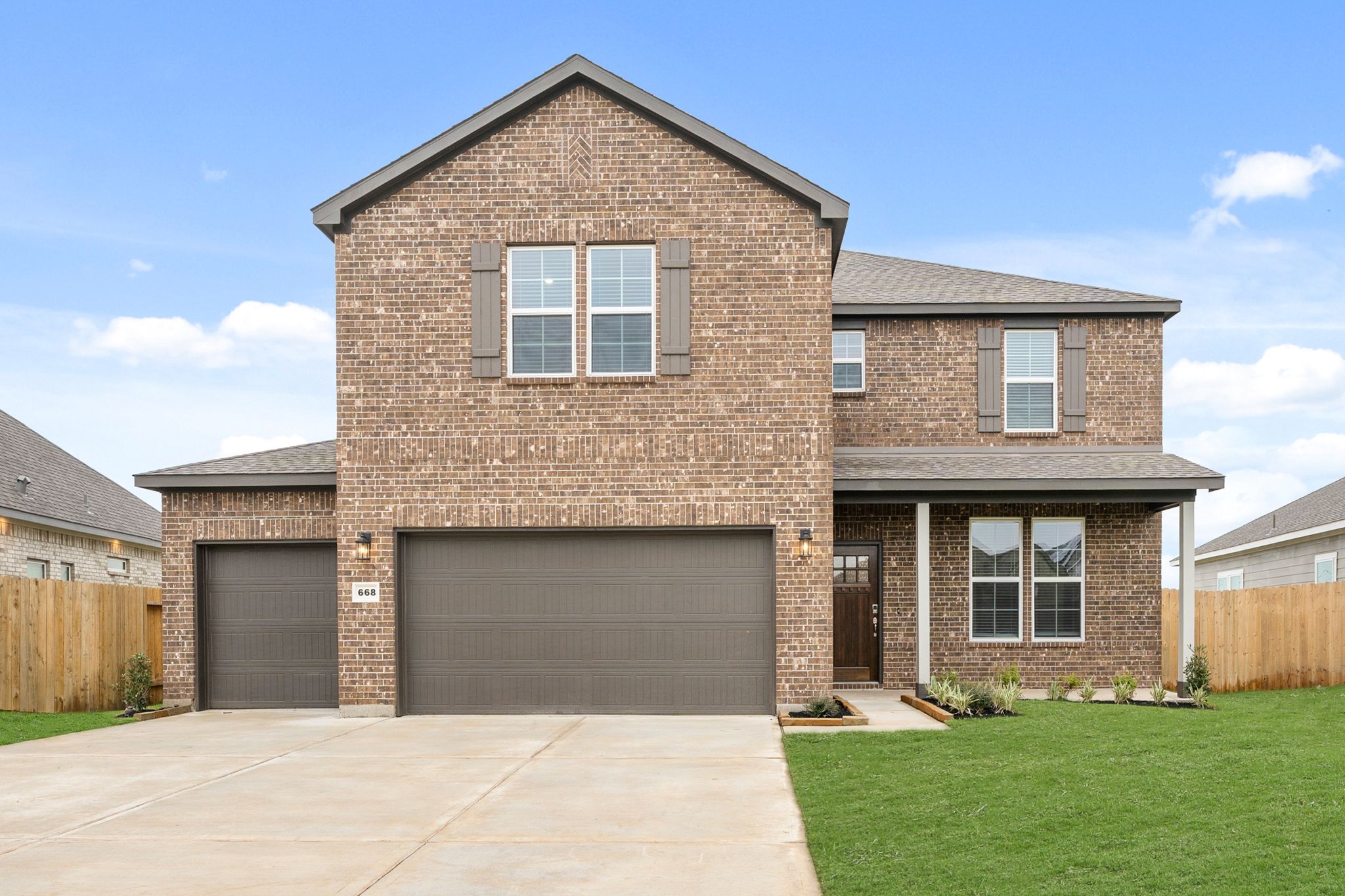 A brick house with a garage.
