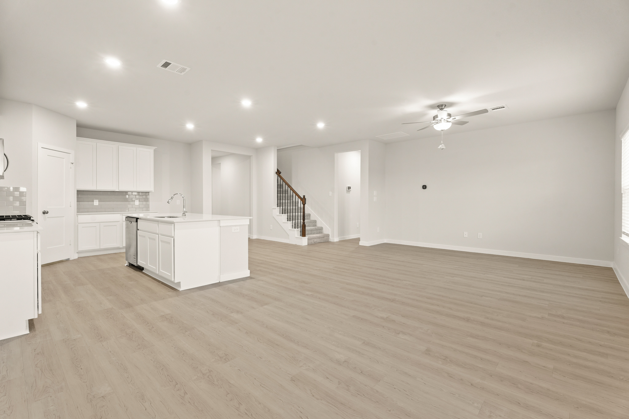 A large kitchen with white cabinets.