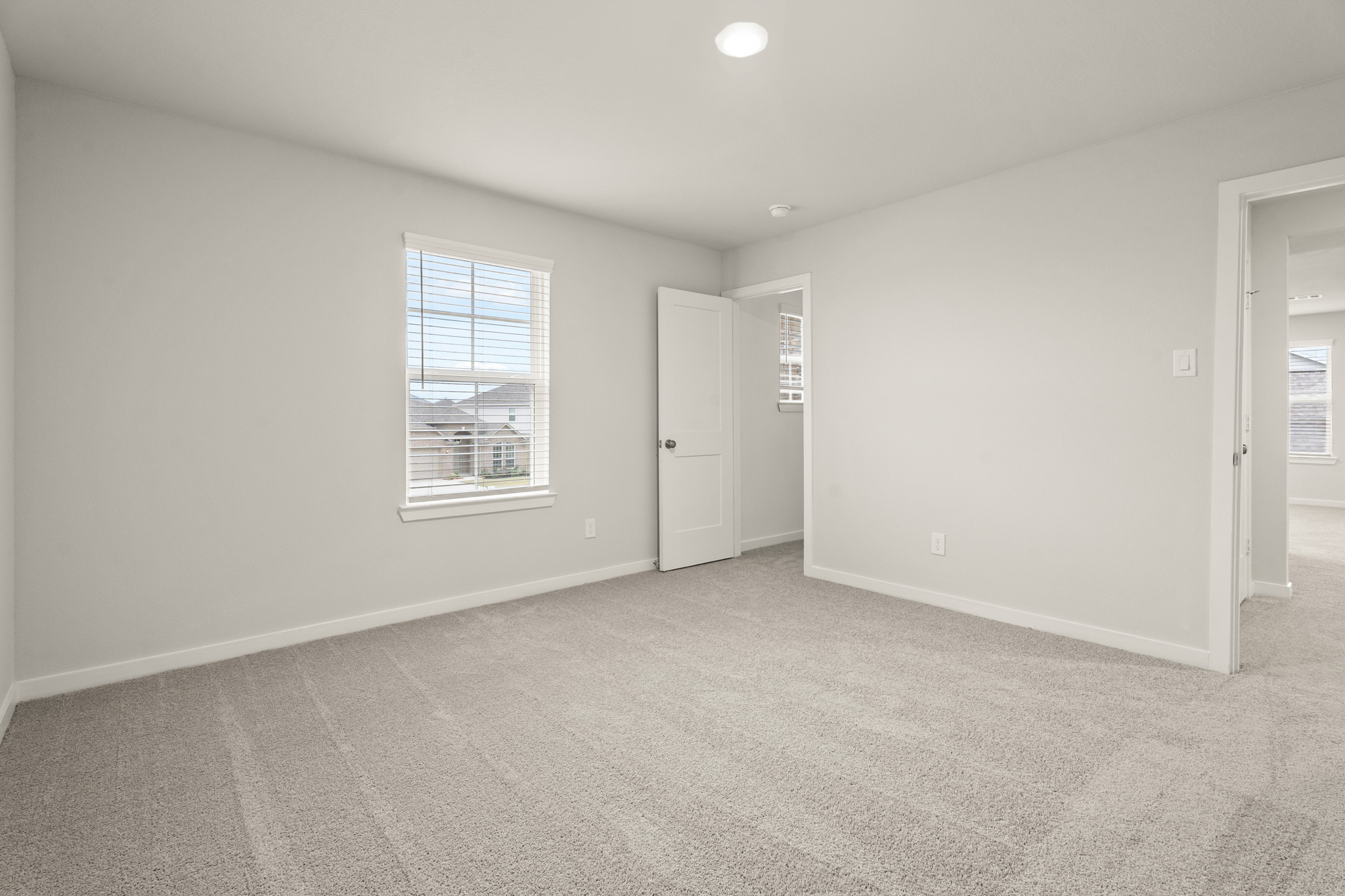 A room with a window and a door.