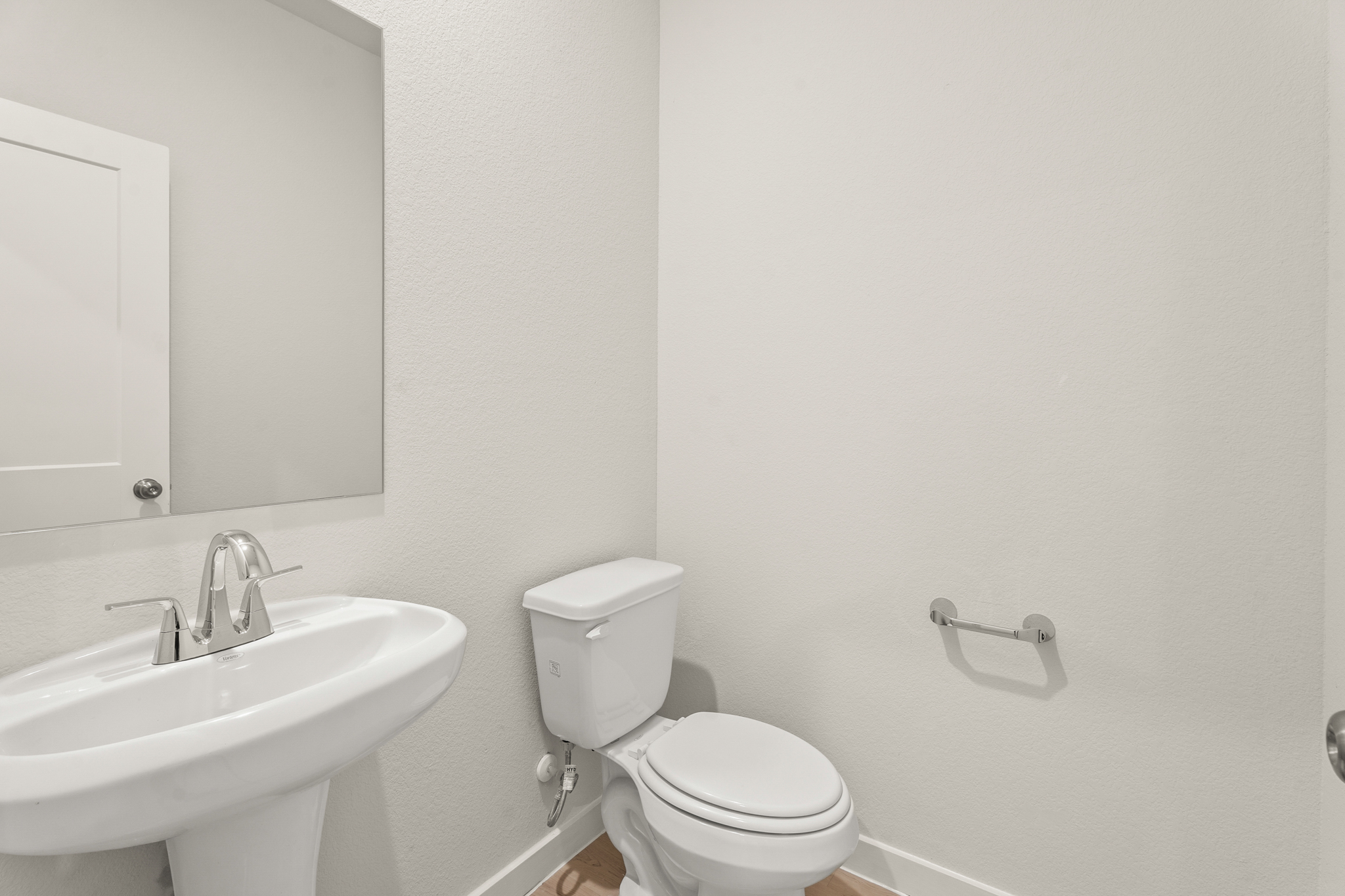 A bathroom with a toilet and sink.
