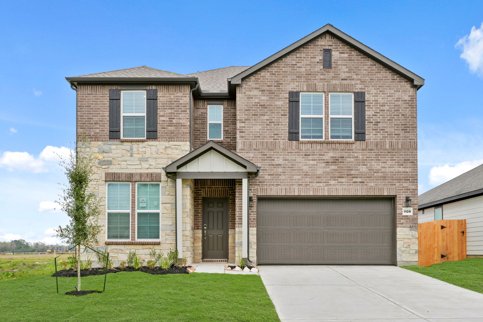 A brick house with a garage.