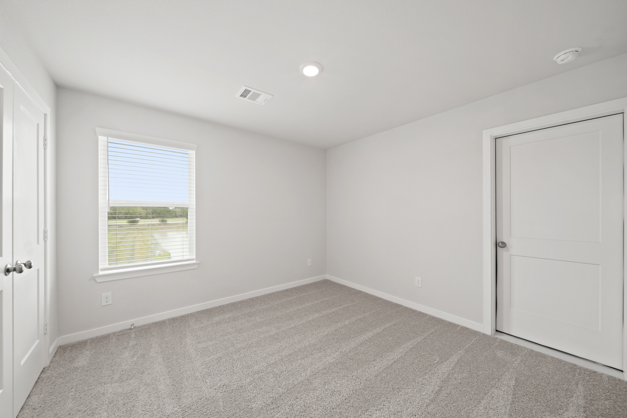 A room with white walls and a window.