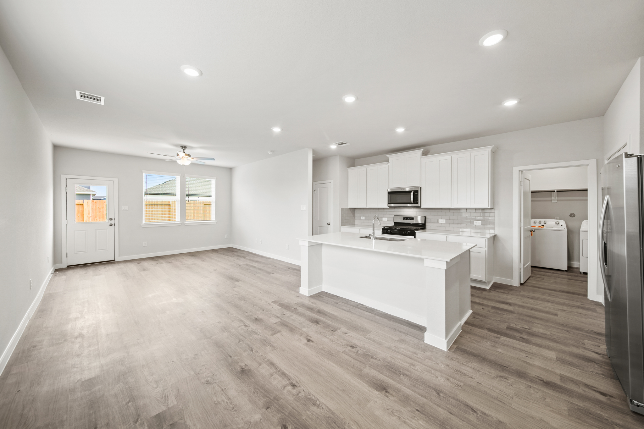 A kitchen with white cabinets.