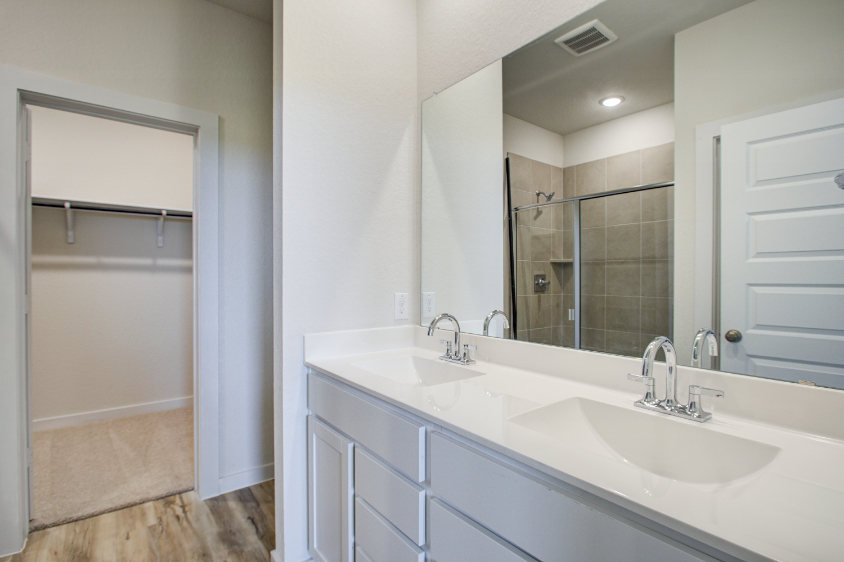 A bathroom with a large mirror.