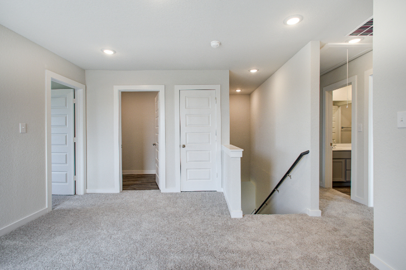 A hallway with white doors.