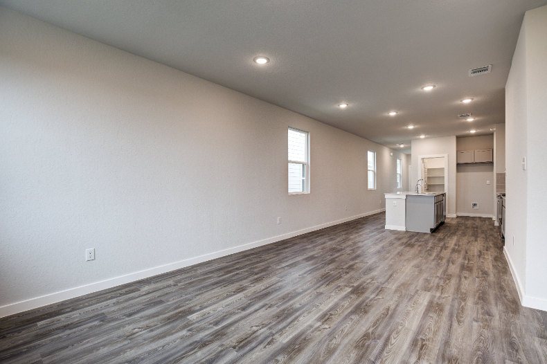 A room with a wood floor and white walls.