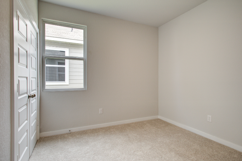 A room with a door and a window.