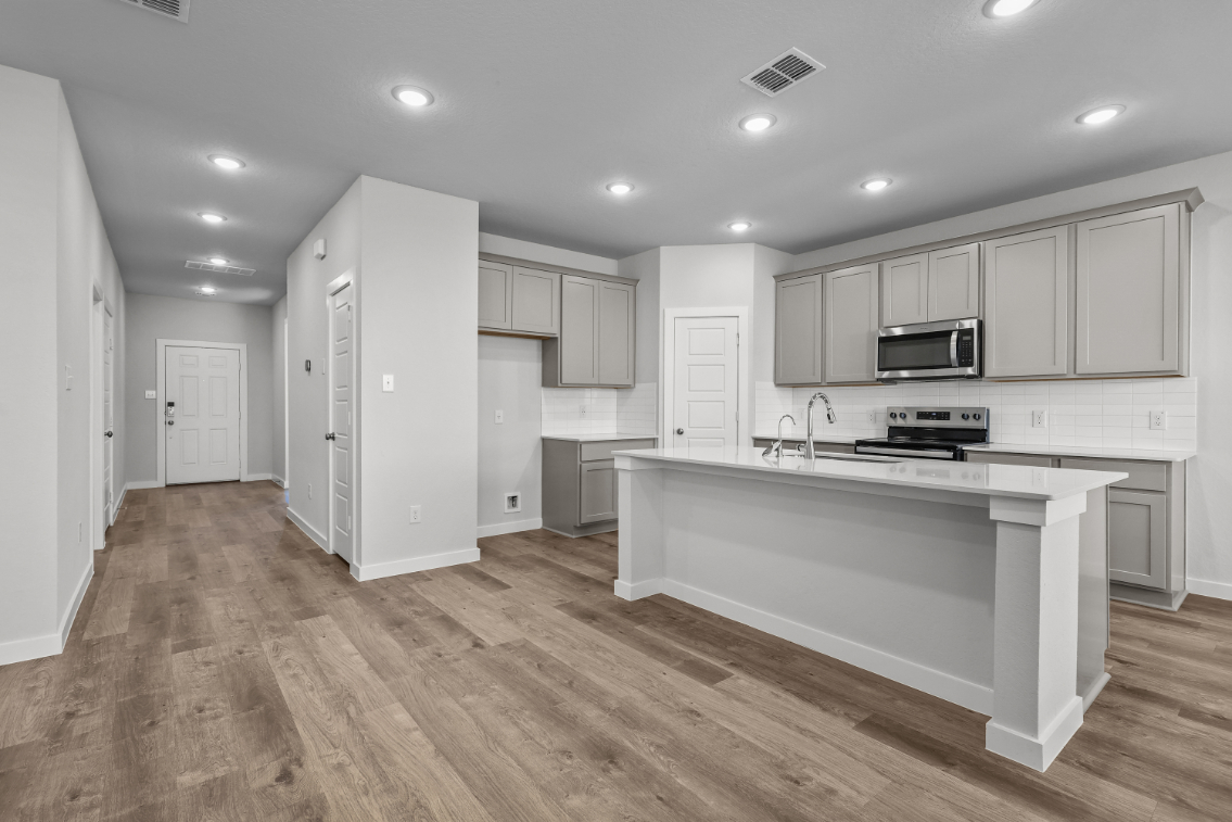 A kitchen with white cabinets.