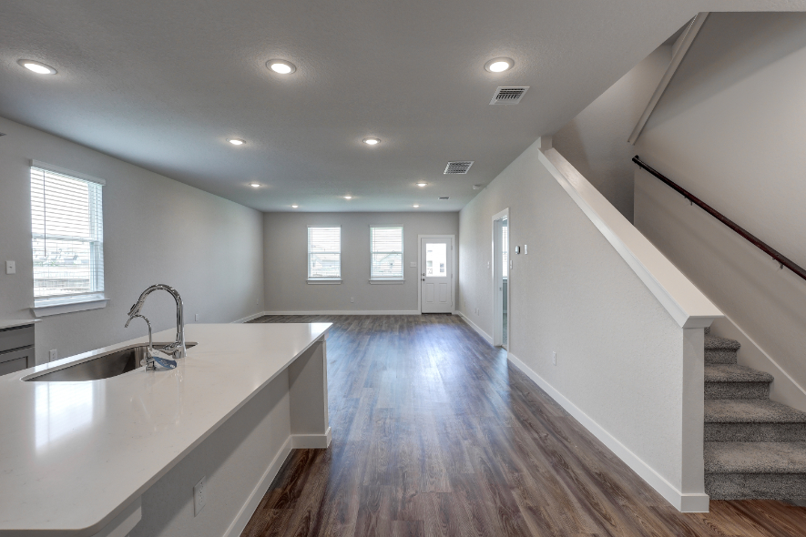 A kitchen with a wood floor.