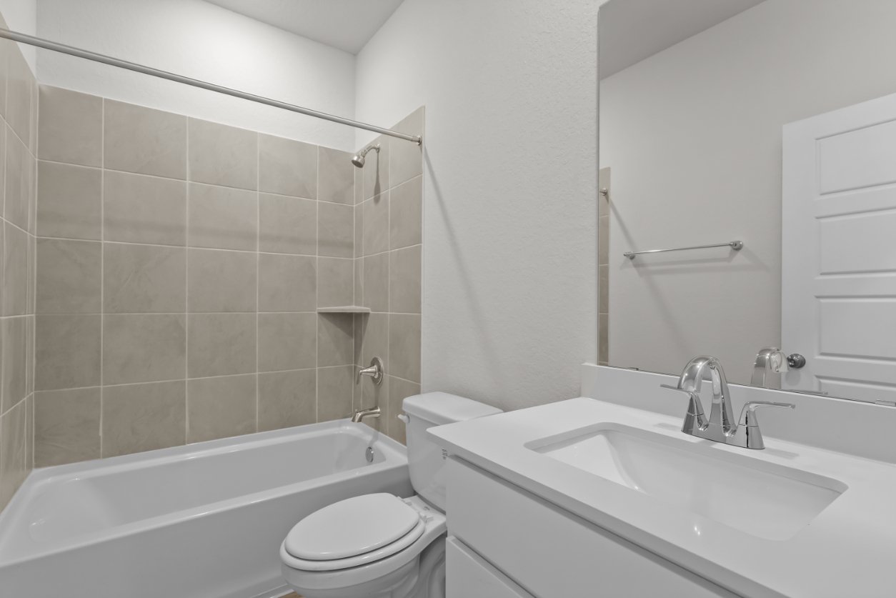 A bathroom with a sink toilet and bathtub.