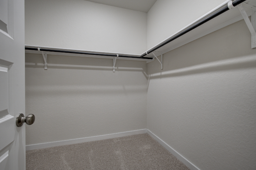 A white wall with a metal railing.
