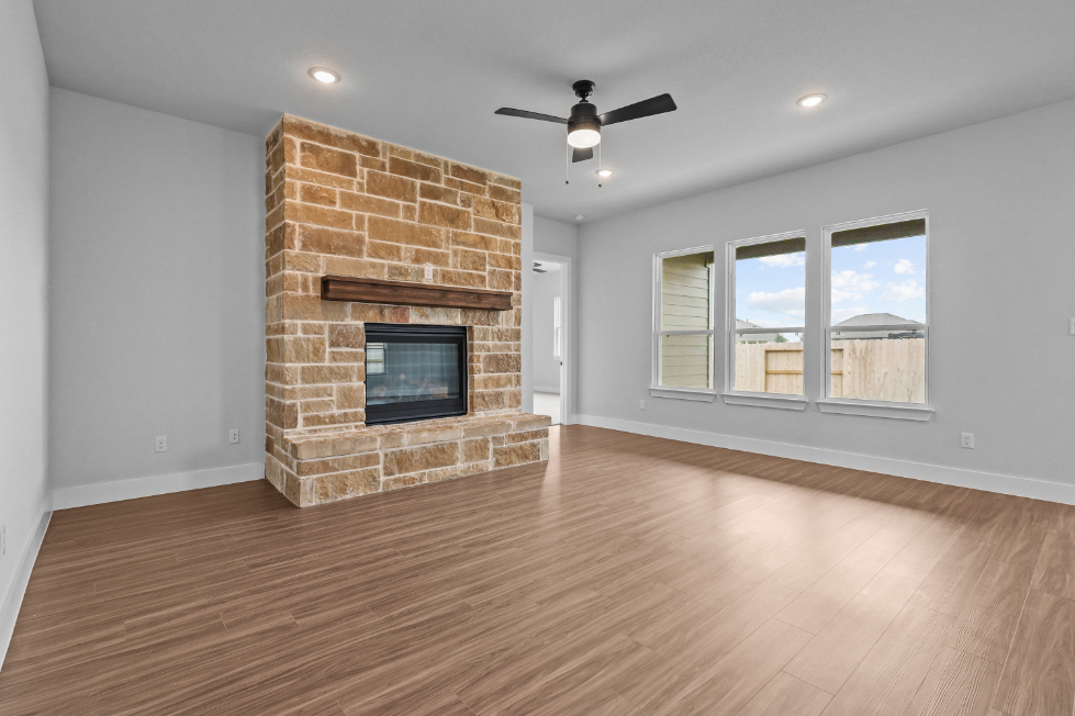 A room with a fireplace and a wood floor.
