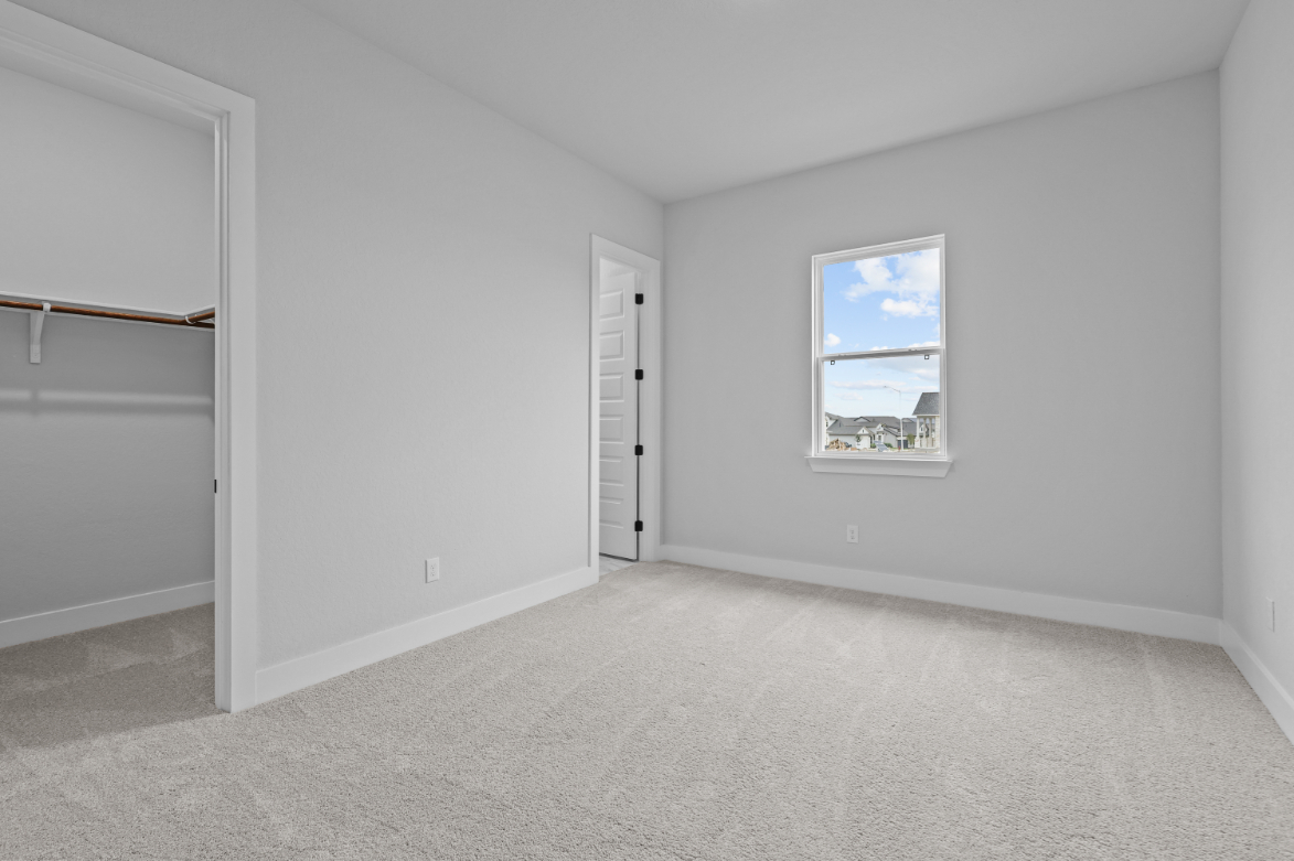 A room with a window and a door.