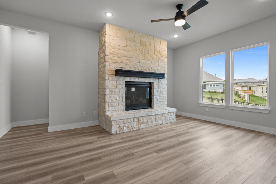 A room with a fireplace and a wood floor.