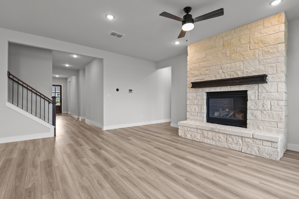 A large living room with a fireplace.