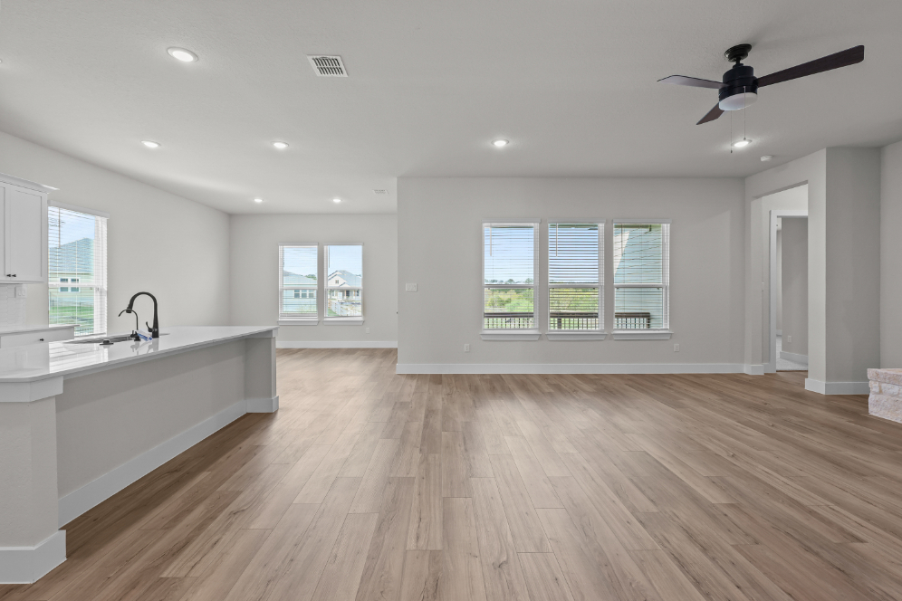 A large kitchen with a wood floor.