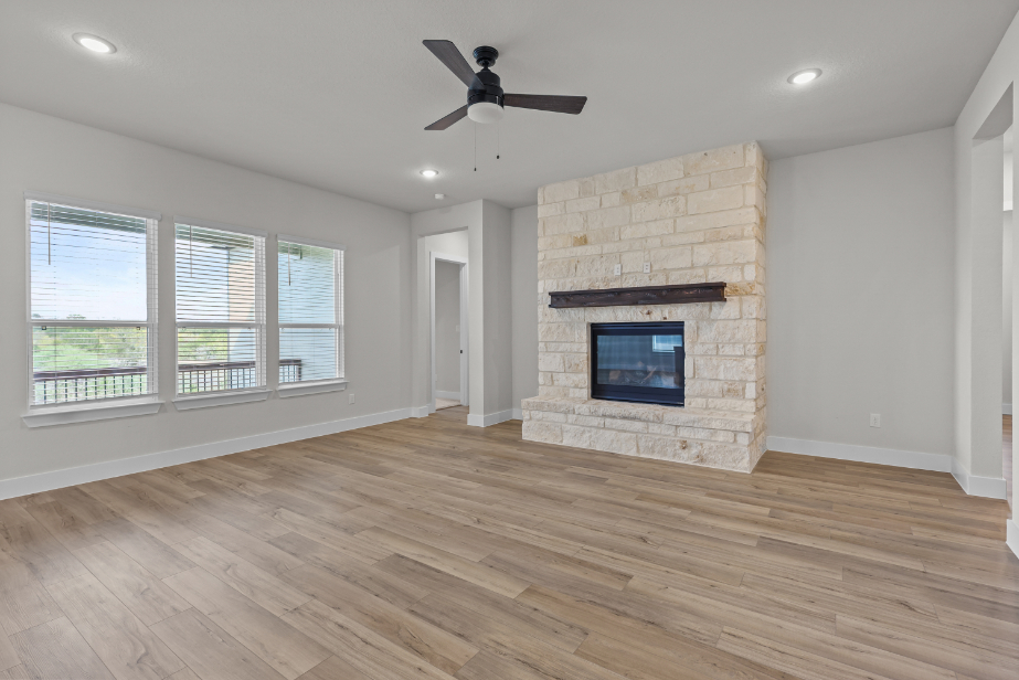 A room with a fireplace and a wood floor.