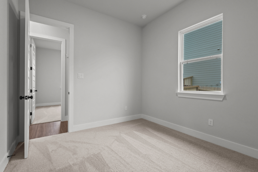 A room with a window and a door.