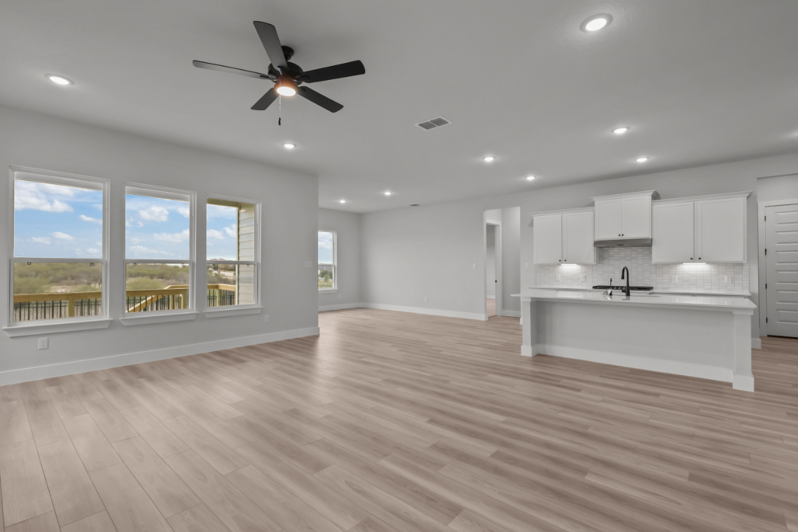 A large empty kitchen with a large window.