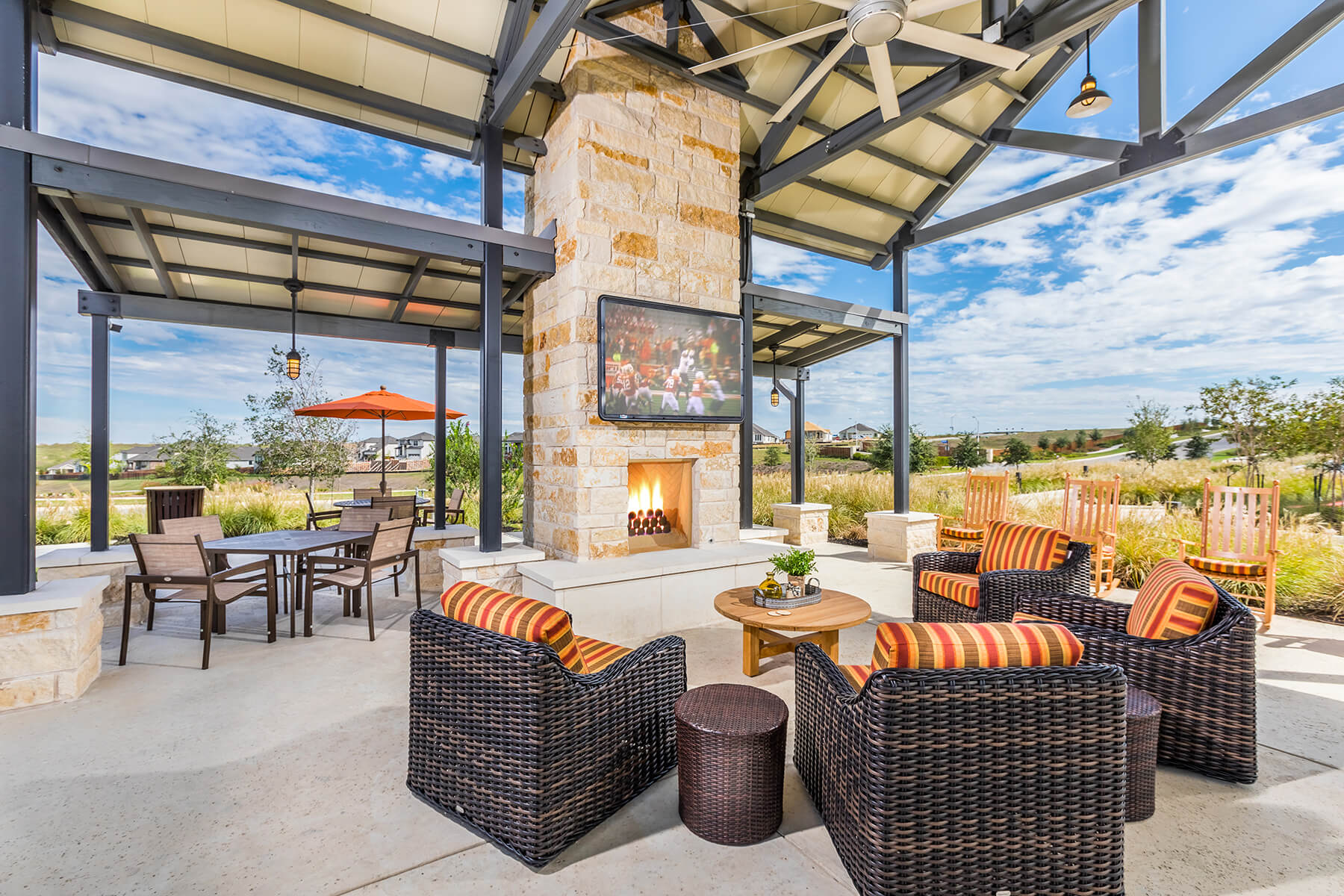 A patio with chairs and tables.