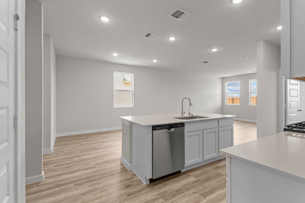 A kitchen with white cabinets.