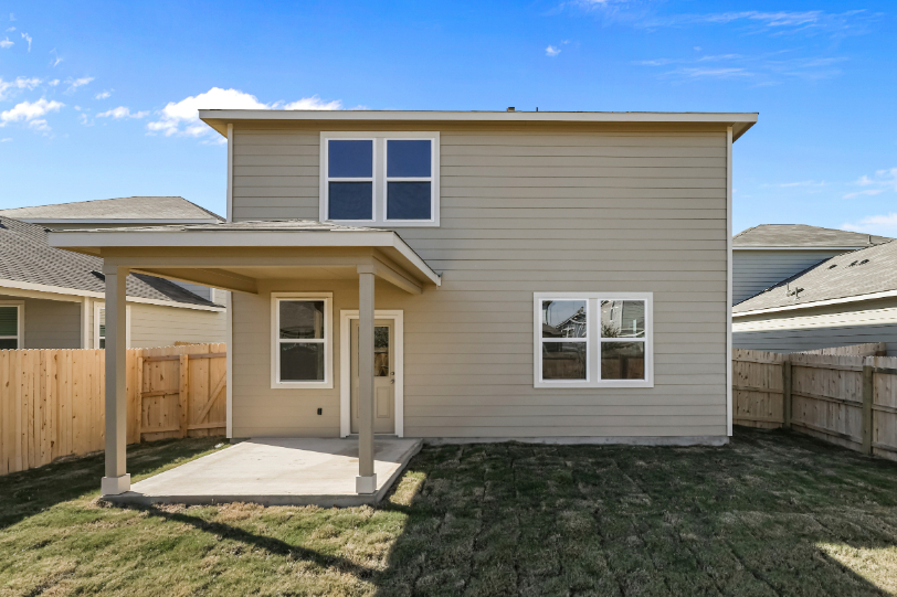 A house with a fence and a yard.
